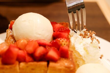 Strawberry honey toast with ice cream and whipcreamの写真素材