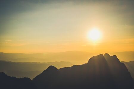 sunrise sky backlit with big mountainの写真素材