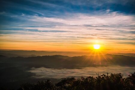 sunrise backlit sky with cloud on the top of mountain