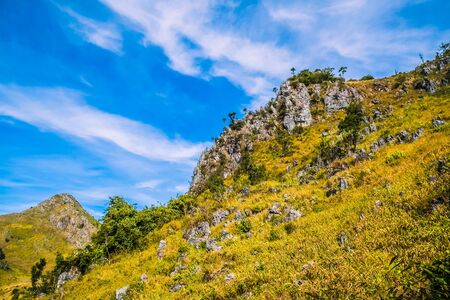 nature green hills with blue sky backgroundの写真素材