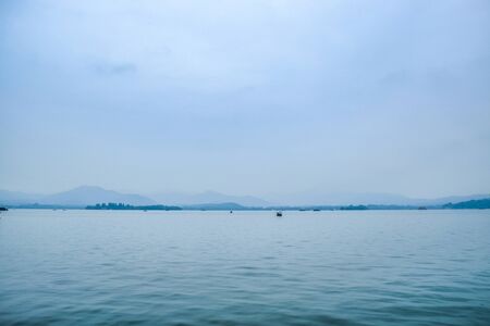grand lake with white sky background and treesの写真素材