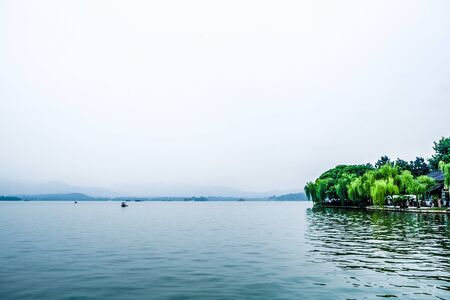 grand lake with white sky background and treesの写真素材