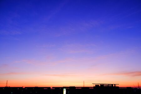 sunset sky shading background from orange to blueの写真素材