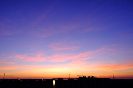 sunset sky shading background from orange to blueの写真素材