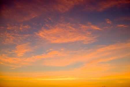 sunset sky shading background from orange to blueの写真素材