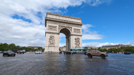 Arc de Triomphe: paris france -July2 ,2023: Cars drive on the road next to the Arc de Triomphe in Parisのeditorial素材