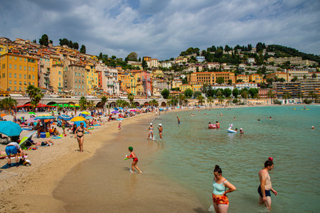 Menton Beach:Menton, France -June 22 ,2023:Many tourists play with water at Menton Beachのeditorial素材