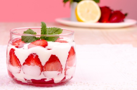 Strawberry dessert with cream on a pink background, close-upの写真素材