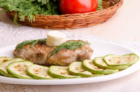 Juicy pork with melting butter and zucchini slices, close-upの写真素材