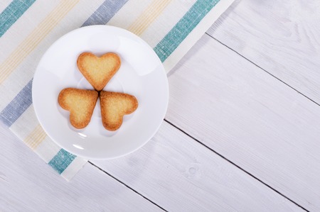 Cookies in the shape of a heart on a saucer, top viewの写真素材