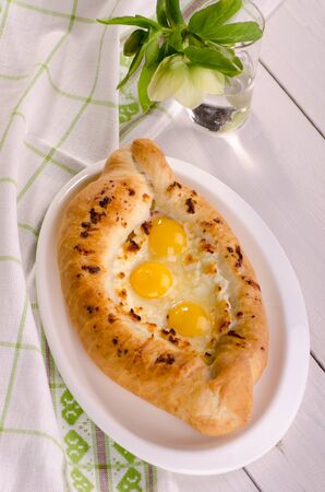 Pie with cheese and eggs - khachapuri - traditional Georgian dishの写真素材