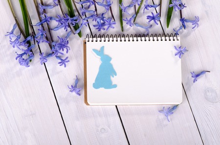 Spring flowers on the table with a notebook for notes, Easter card