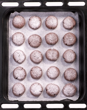 Ready-made chocolate cookies on a baking sheet, top viewの写真素材
