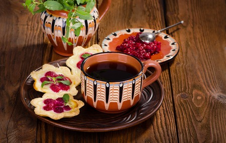 Raspberry dessert tarts with berries and mint tea, delicious breakfastの写真素材
