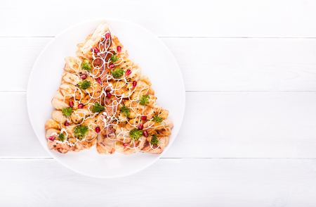 Christmas cakes, puff in the shape of a Christmas tree with cheese and broccoli, top view.の写真素材