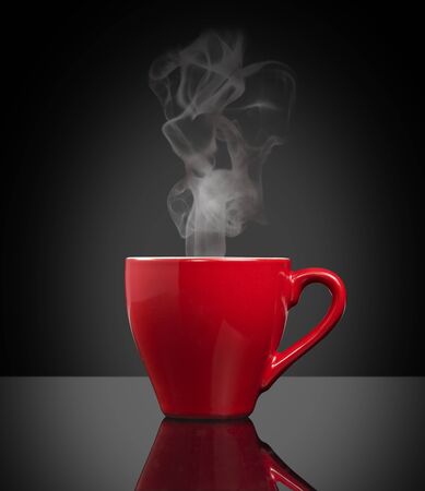 red cup of steamy coffee on black backgroundの写真素材