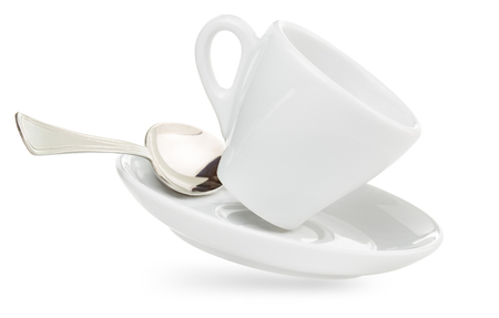 porcelain coffee cup on saucer with spoon isolated on whiteの写真素材