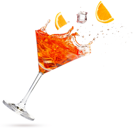 orange and ice cube falling into a splashing martini isolated on whiteの写真素材
