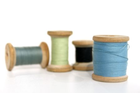 Four reels  with threads of different colorの写真素材