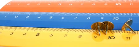 Colour rulers with pushpins, a close upの写真素材