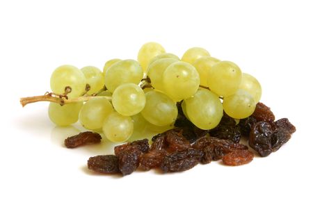 Bunch of grapes and raisins on a white backgroundの写真素材