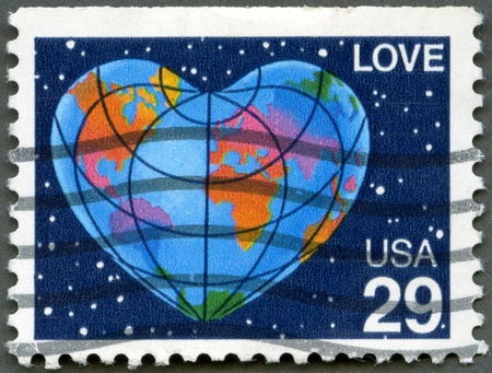 UNITED STATES OF AMERICA - CIRCA 1991  A stamp printed in USA shows word  love  and Earth in Form of the Heart, circa 1991の写真素材