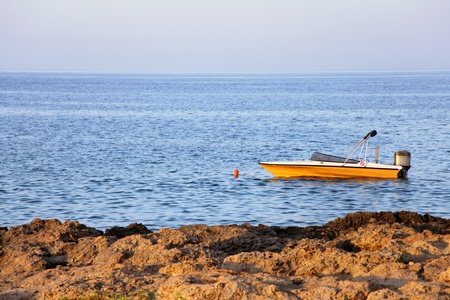 Motorboat on calm sea water near coastの写真素材