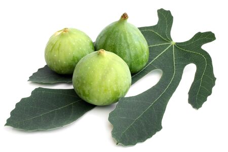 Ripe figs with green leaf on a white background