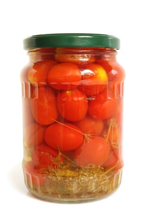 Cherry tomatoes canned in glass jar on a white backgroundの写真素材