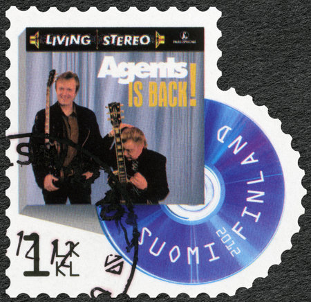 FINLAND - CIRCA 2012: A stamp printed in Finland shows band Agents, series on Finnish music has reached the 1990's, circa 2012のeditorial素材
