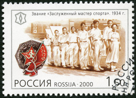 RUSSIA - CIRCA 2000: A stamp printed in Russia shows The title of elder master of sports (1934), series National Sporting Milestones of the 20th Century in Russia, circa 2000のeditorial素材