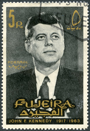 FUJEIRA - CIRCA 1965: A stamp printed in Fujeira shows Portrait of John F. Kennedy (1917-1963), circa 1965のeditorial素材