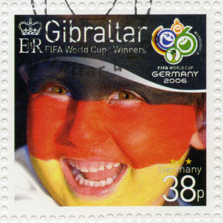 GIBRALTAR - CIRCA 2006 : A stamp printed in Gibraltar shows child with face painted as flag of Germany, devoted 2006 World Cup Soccer Championships, Germany, circa 2006のeditorial素材