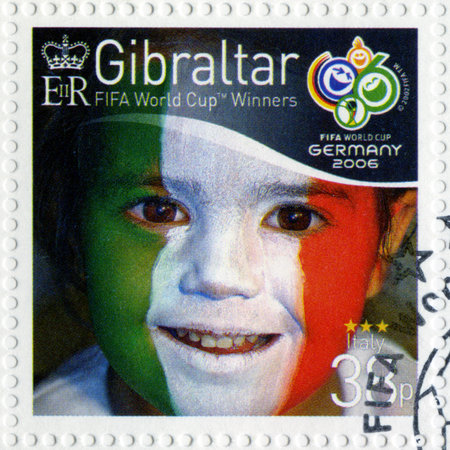 GIBRALTAR - CIRCA 2006 : A stamp printed in Gibraltar shows child with face painted as flag of Italy, devoted 2006 World Cup Soccer Championships, Germany, circa 2006のeditorial素材
