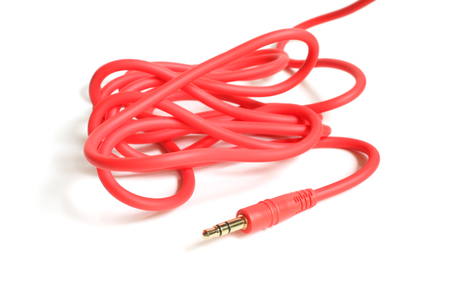 Red audio cable 3,5mm jack plug on white backgroundの写真素材