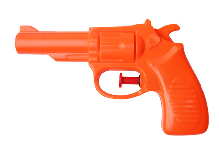 Orange plastic water pistol isolated on white backgroundの写真素材