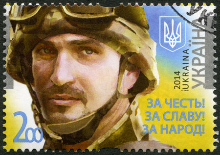 UKRAINE - CIRCA 2014: A stamp printed in Ukraine shows portrait of soldier with the call sign \\\"Frenchman\\\", devoted Legends of the Armed Forces of Ukraine, For the honor! For the glory! For the people!, circa 2014のeditorial素材