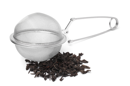 Tea infuser with a handful of tea on white backgroundの写真素材