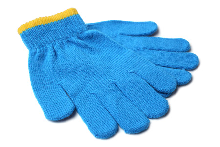 Warm woolen knitted gloves on white background