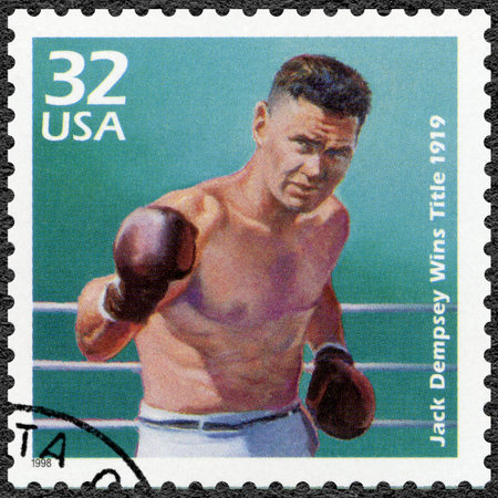 UNITED STATES OF AMERICA - CIRCA 1998: A stamp printed in USA shows Jack Dempsey wins heavyweight title, 1919, series Celebrate the Century, 1910s, circa 1998のeditorial素材