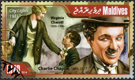 MALDIVES - CIRCA 2014: A stamp printed in Maldives shows portrait of Charlie Chaplin (1889-1977) and Virginia Cherrill (1908-1996), film City Lights, 1931, circa 2014のeditorial素材