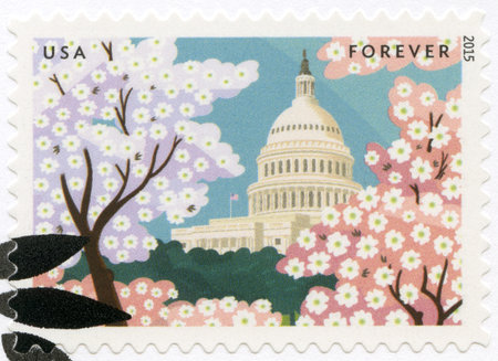 USA - CIRCA 2015: A stamp printed in USA shows The United States Capitol with flowering dogwood and flowering cherry trees, circa 2015のeditorial素材