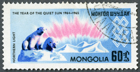 MONGOLIA - CIRCA 1965: A stamp printed in Mongolia shows Northern lights and polar bears, series International Quiet Sun Year, circa 1965のeditorial素材