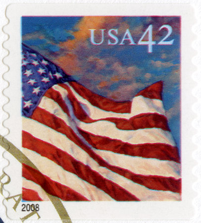 UNITED STATES OF AMERICA - CIRCA 2008: A stamp printed in the USA shows an American Flag flying in the breeze at sunset, series Flag 24/7, circa 2008のeditorial素材