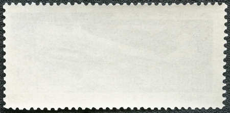 Blank postage stamp on a black backgroundの写真素材