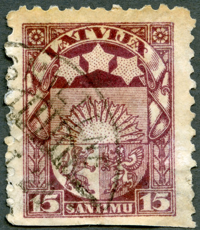 LATVIA - CIRCA 1923: A stamp printed in Latvia shows Litvian Arms, circa 1923のeditorial素材
