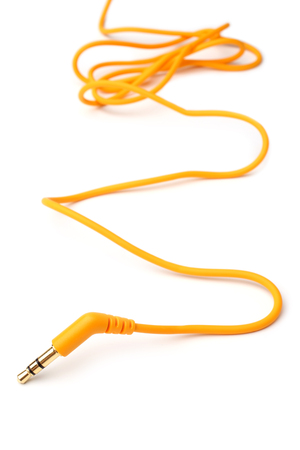 Orange audio cable 3,5mm jack plug on white background