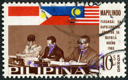 PHILIPPINES - CIRCA 1965: A stamp printed in Philippines shows Presidents Sukarno and Macapagal and Prime Minister Tunku Abdul Rahman, Signing of the Manila Accord (Mapilindo) by
 Malaya, Philippines and Indonesia, circa 1965のeditorial素材