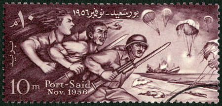 EGYPT - CIRCA 1956: A stamp printed in Egypt shows Egyptians Defending Port Said, Honoring the defenders of Port Said, circa 1956のeditorial素材