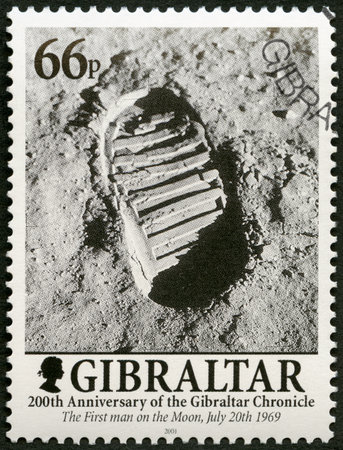 GIBRALTAR - CIRCA 2001: A stamp printed in Gibraltar shows Footprint on the Moon, Man walks on the Moon, 200 Years of the Gibraltar Chronicle, circa 2001のeditorial素材